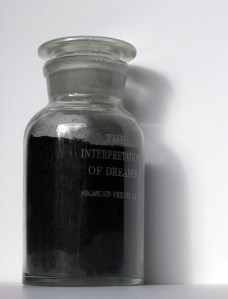 Dream work, carbon remains of Sigmund Freud's The Interpretation of Dreams in etched glass reagent bottle